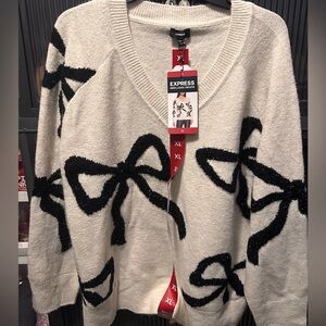 Express Cream V-Neck Sweater with Black Bow Motif